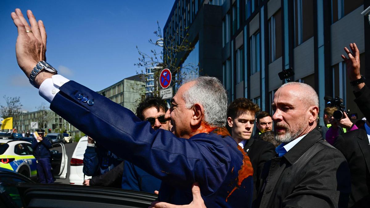 Reza Pahlavi splattered with red liquid in Berlin